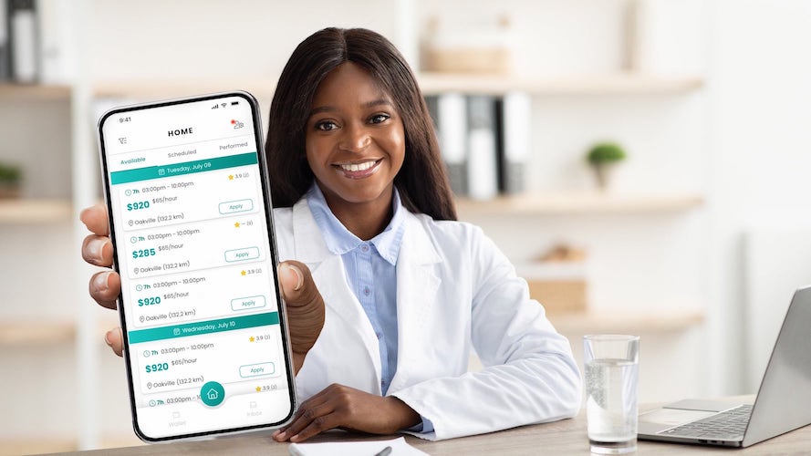 Female Pharmacist holding a phone with instaLocum app opened